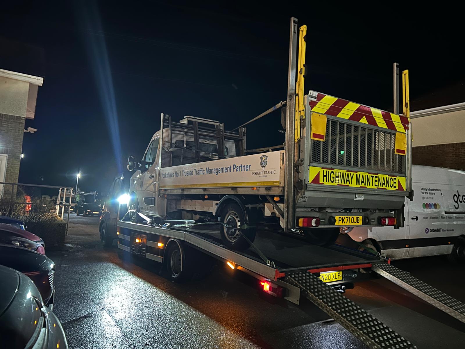 Highway maintenance vehicle being recovered at night